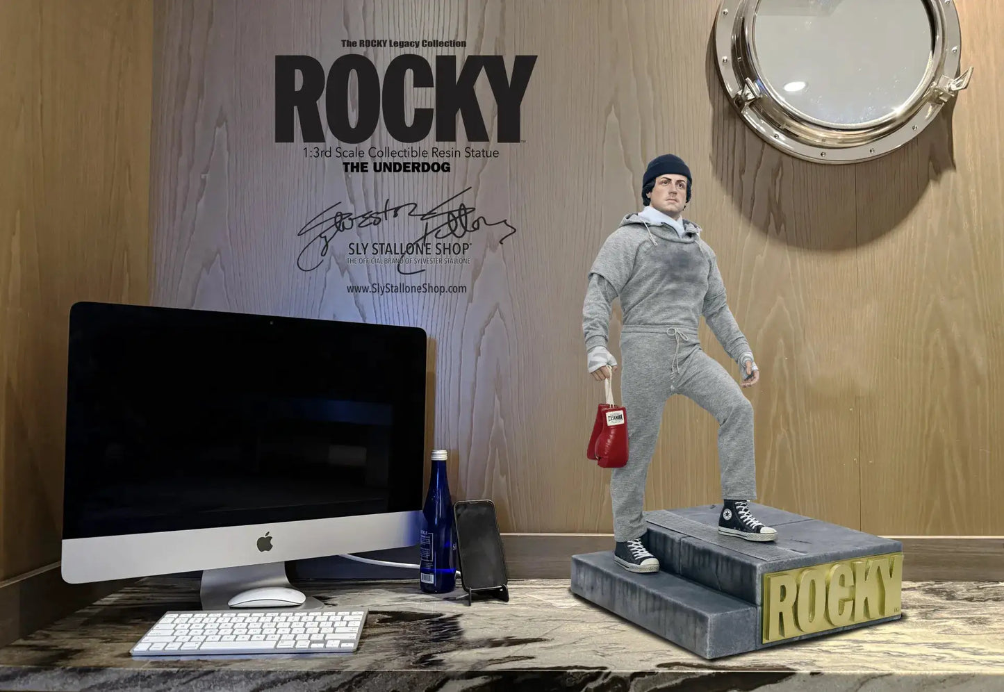 Rocky Balboa 1/3 scale statue (63 cm) in grey hoodie with red boxing gloves, by SLY STALLONE SHOP, on a ROCKY pedestal.