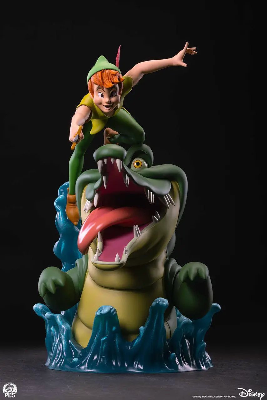 Peter Pan 1:5 Scale Statue perched on a green crocodile with blue water spray; Disney and PCS logos visible.