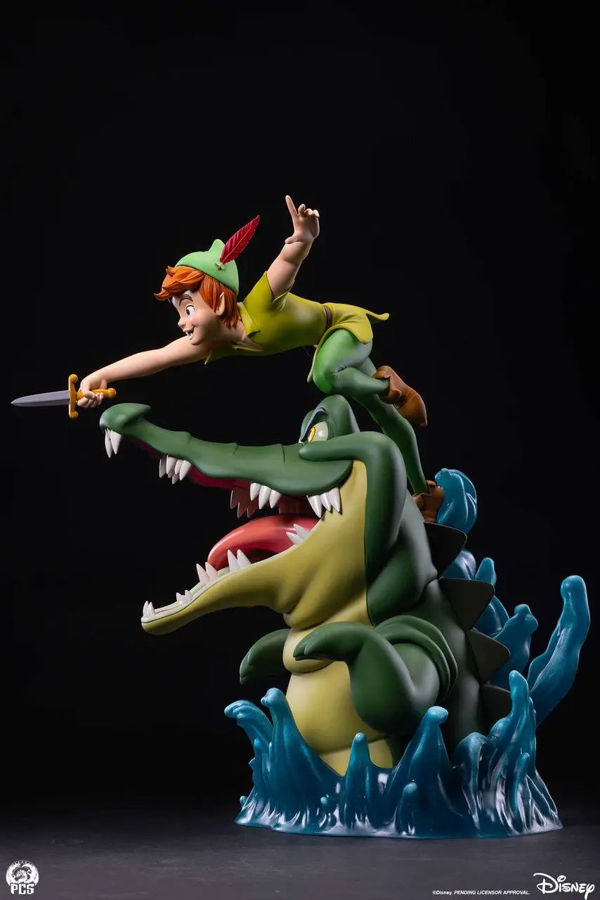 Peter Pan 1:5 scale statue riding a green crocodile with open jaws, sword drawn, blue wave base; PCS logo.