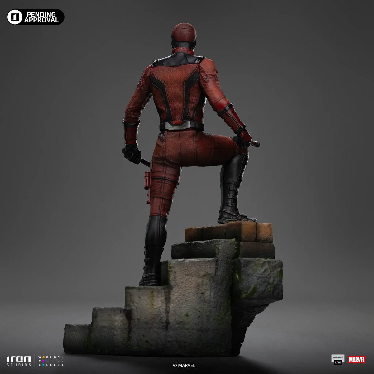 Daredevil statue from Daredevil: Born Again in red suit, Iron Studios 1/10 scale, back view on stone pedestal.