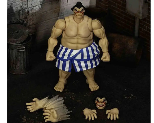 Figura de acción E. Honda 1/12 de Jada Toys, Ultra Street Fighter II; shorts azul y blanco a rayas, con manos y cabeza intercambiables.