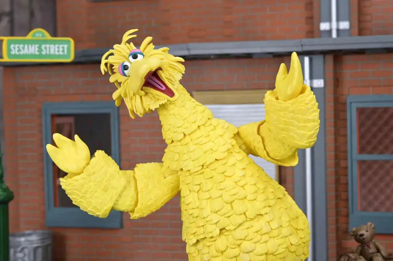 Sesame Street Big Bird Ultimate Action Figure, yellow feathered figure with open beak against Sesame Street backdrop