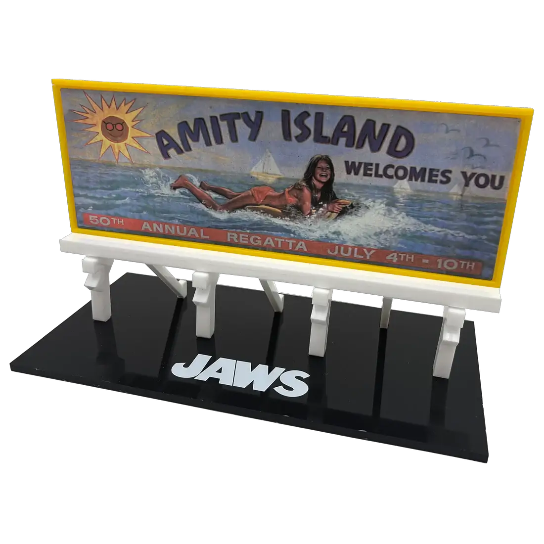 Jaws Amity Island billboard prop replica on a black display base; yellow-framed sign with Amity Island image and JAWS logo