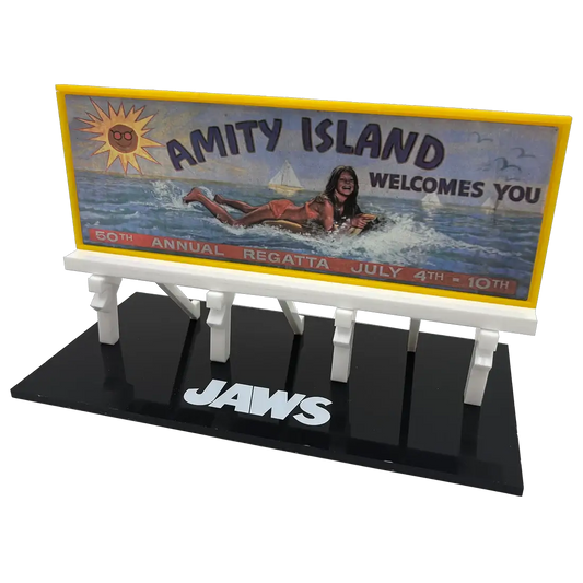 Jaws Amity Island billboard prop replica on a black display base; yellow-framed sign with Amity Island image and JAWS logo
