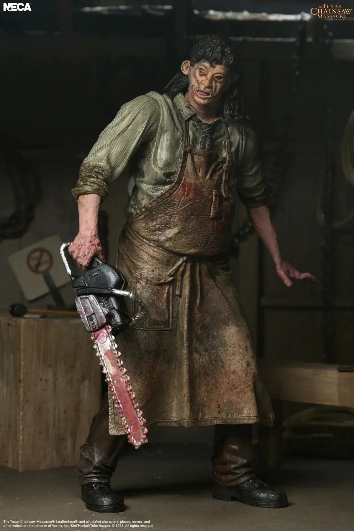 NECA action figure of Leatherface from The Texas Chainsaw Massacre: The Beginning, bloodied apron, chainsaw.