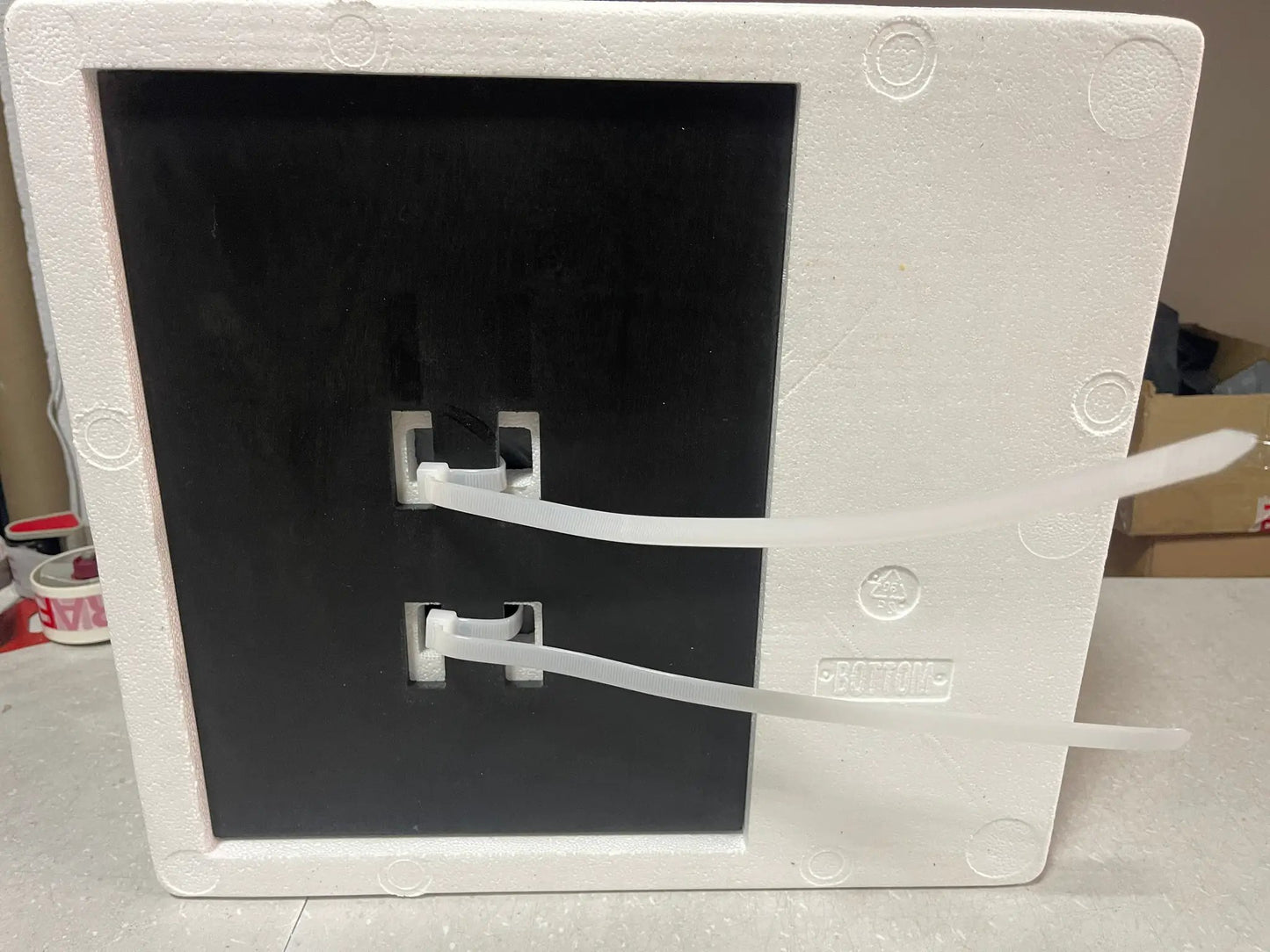 RoboCop helmet replica packaging: white Styrofoam crate with black inner panel and white securing straps.