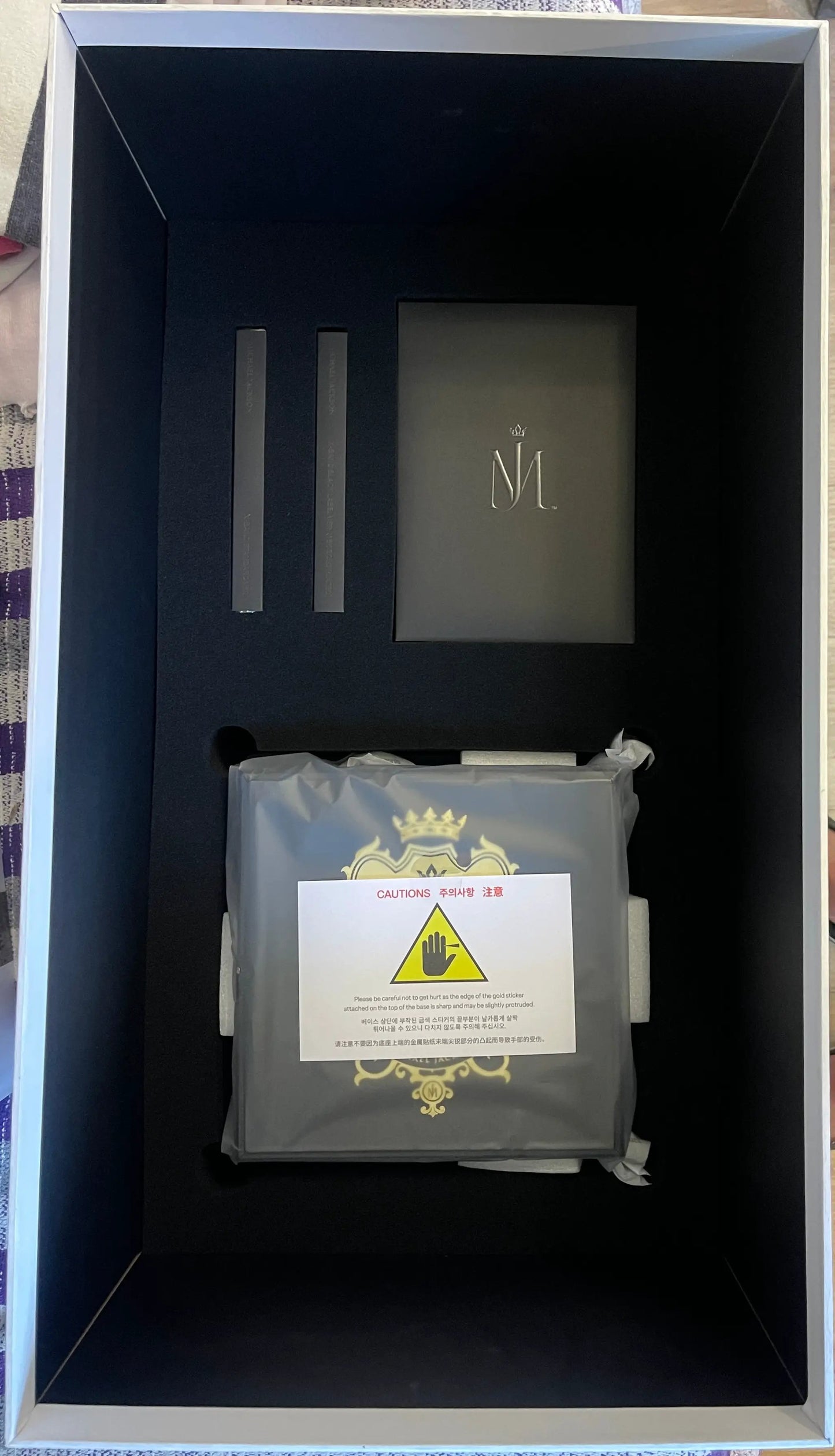 Michael Jackson Black Label 1/4 Scale Statue packaging; black interior foam with two slots and a booklet with M emblem