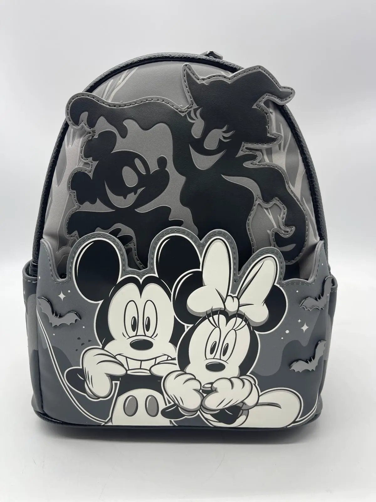 Backpack by Loungefly featuring Mickey & Minnie in grayscale with ghost silhouette and light-up glow