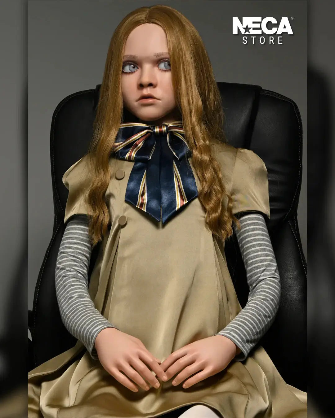 Megan doll 1/1 replica by NECA, 140 cm, beige dress with navy striped bow, gray striped sleeves, seated in chair