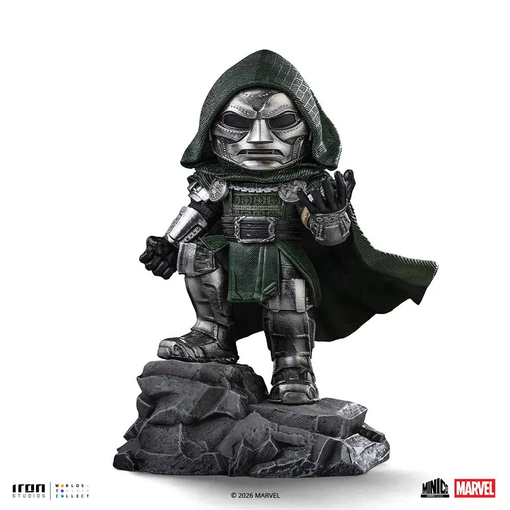 Statue Doctor Doom Minico by Iron Studios in green cloak with metallic armor on rocky base.