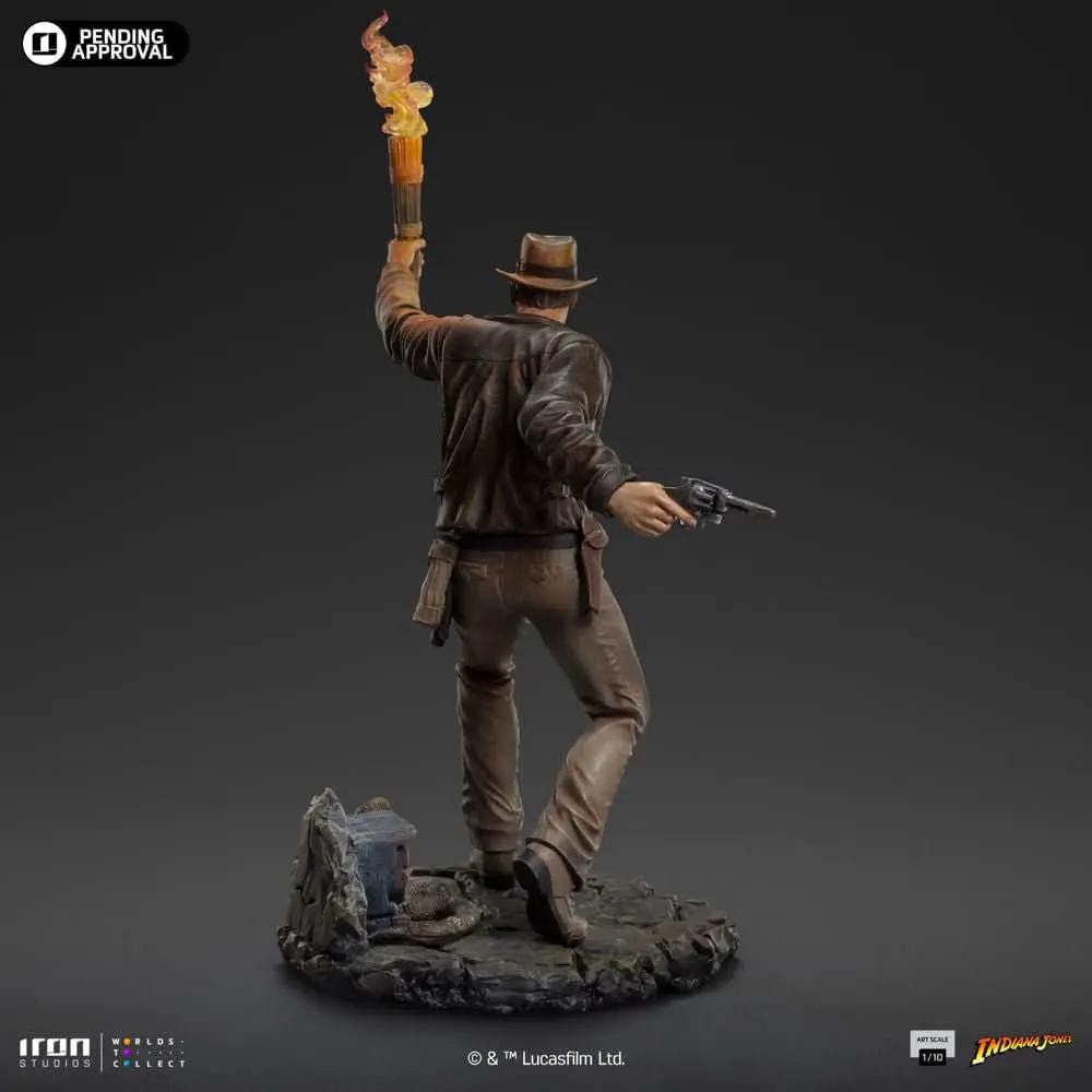Indiana Jones Art Scale 1/10 statue by Iron Studios; Indy in brown jacket and hat, torch raised with flame, pistol in hand on a rocky base