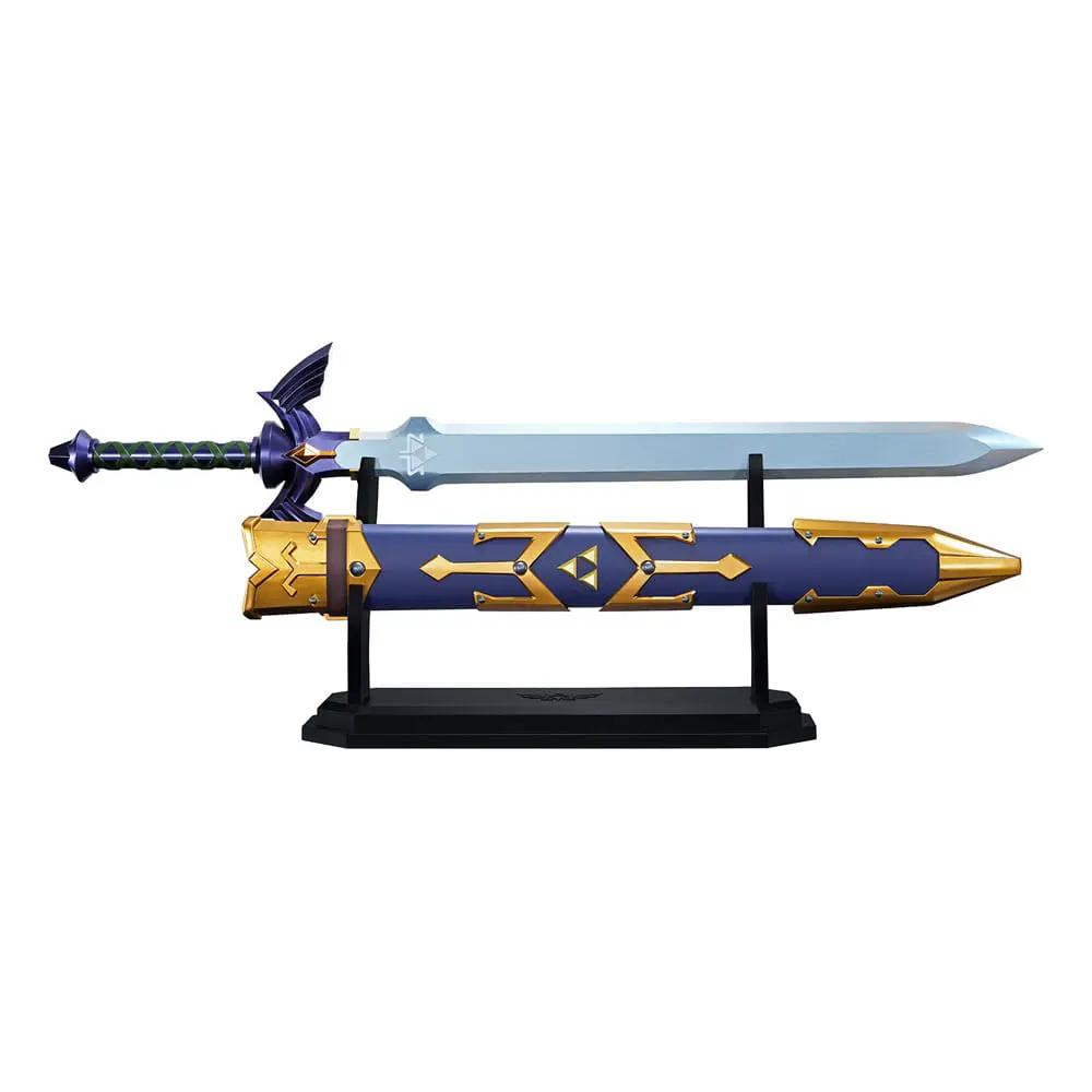 Master Sword Proplica replica by Bandai on display stand, blue and gold sheath with green-wrapped grip.