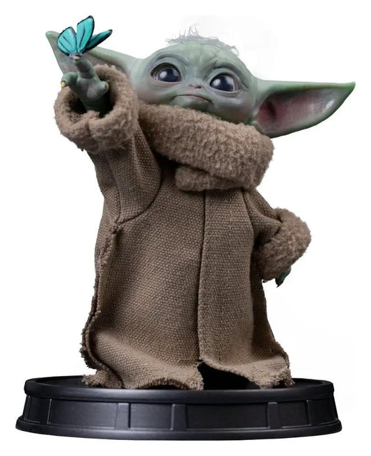 IRON STUDIOS Grogu statue from Mandalorian collection, brown robe, blue butterfly on outstretched finger, on black base