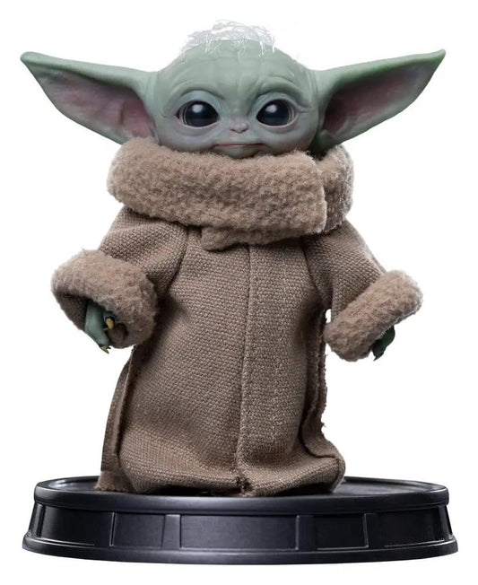 The Mandalorian Grogu statue by Iron Studios in a beige fabric robe on a black display base.