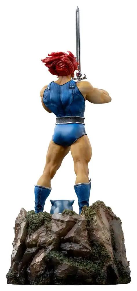 Lion-O ThunderCats statue, 1/10 scale by Iron Studios, red hair, blue outfit, sword raised on rocky base.