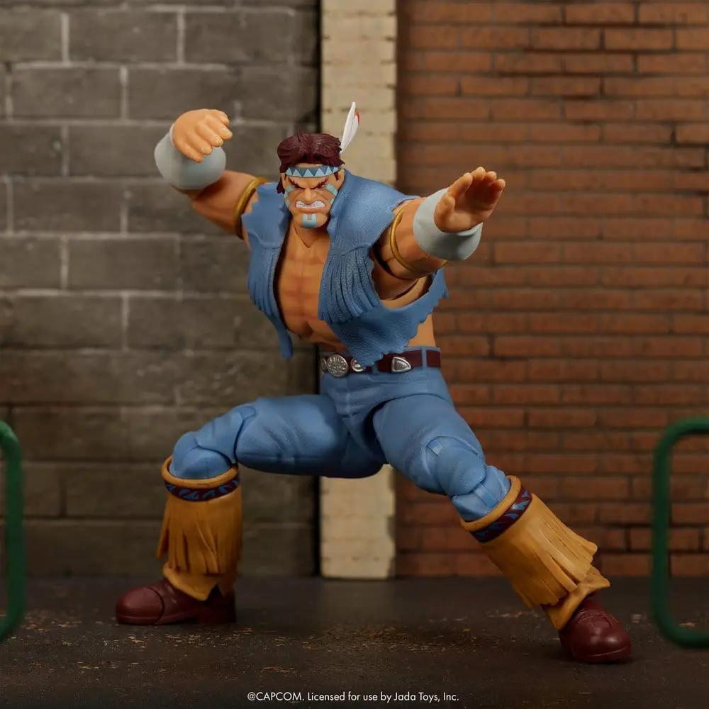Action figure Hawk from Ultra Street Fighter II by Jada Toys, 1/12 scale in blue outfit with tan fringed leg guards.