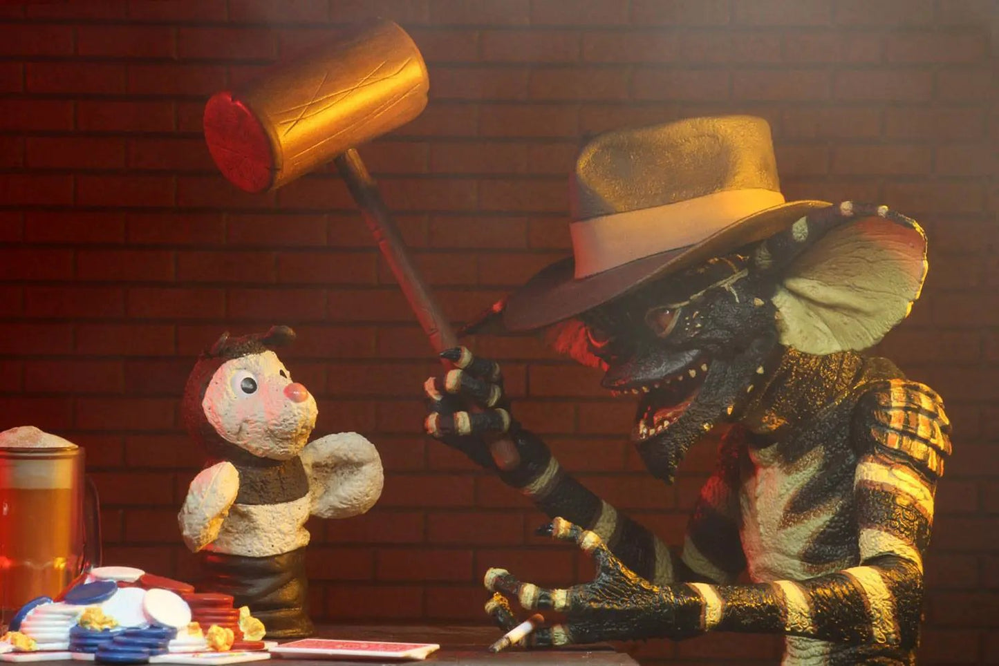 NECA Gremlins Ultimate Flasher Gremlin 15 cm action figure wielding a wooden hammer beside a white plush toy