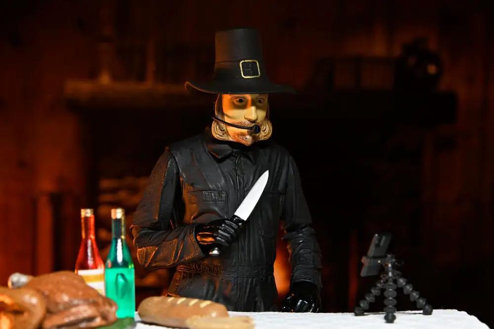 John Carver 18 cm Thanksgiving figure by NECA in black outfit with knife and hat, on table with bread and bottles