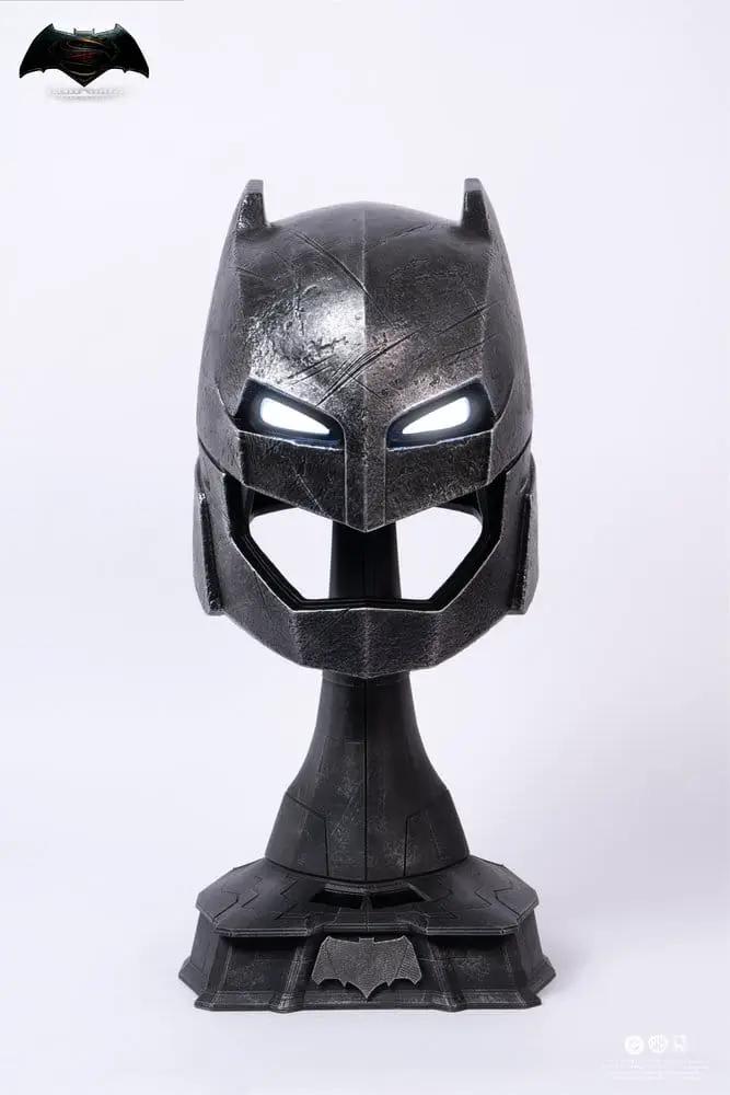 Armored Batman helmet replica by PURE ARTS on display bust, metallic finish with glowing eyes and scratched texture.
