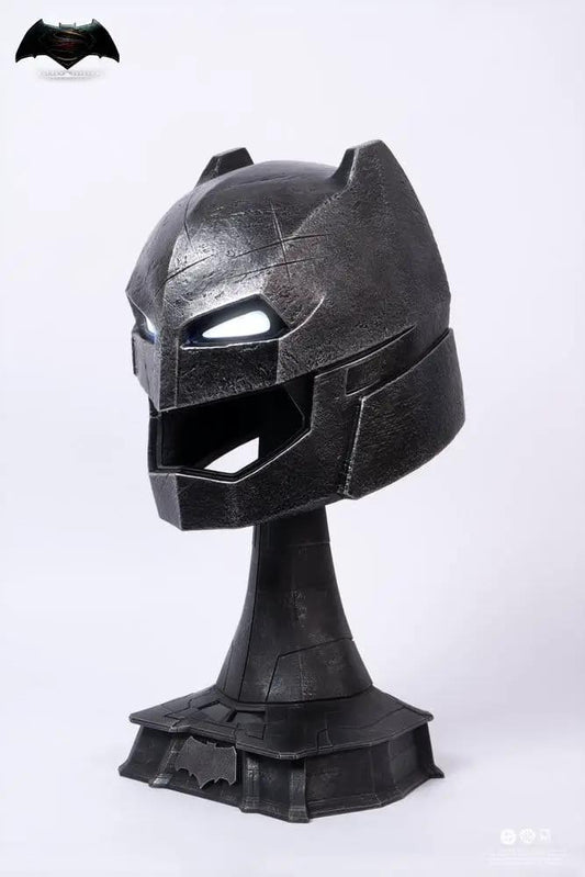 Armored Batman helmet replica on display stand; black metallic finish with glowing eyes