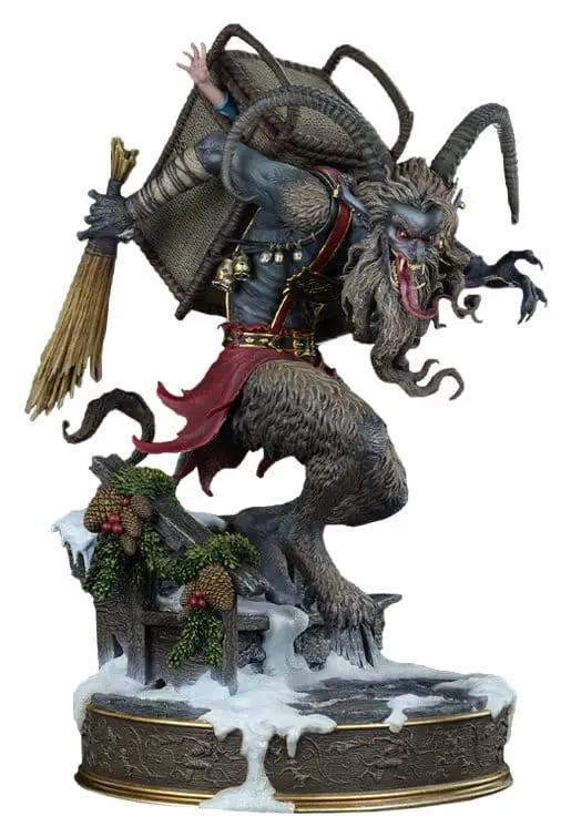 Krampus statue, 48 cm, gray fur, horns and red cape, on snow-dusted base with pine garland; Kimera y Foley Shop