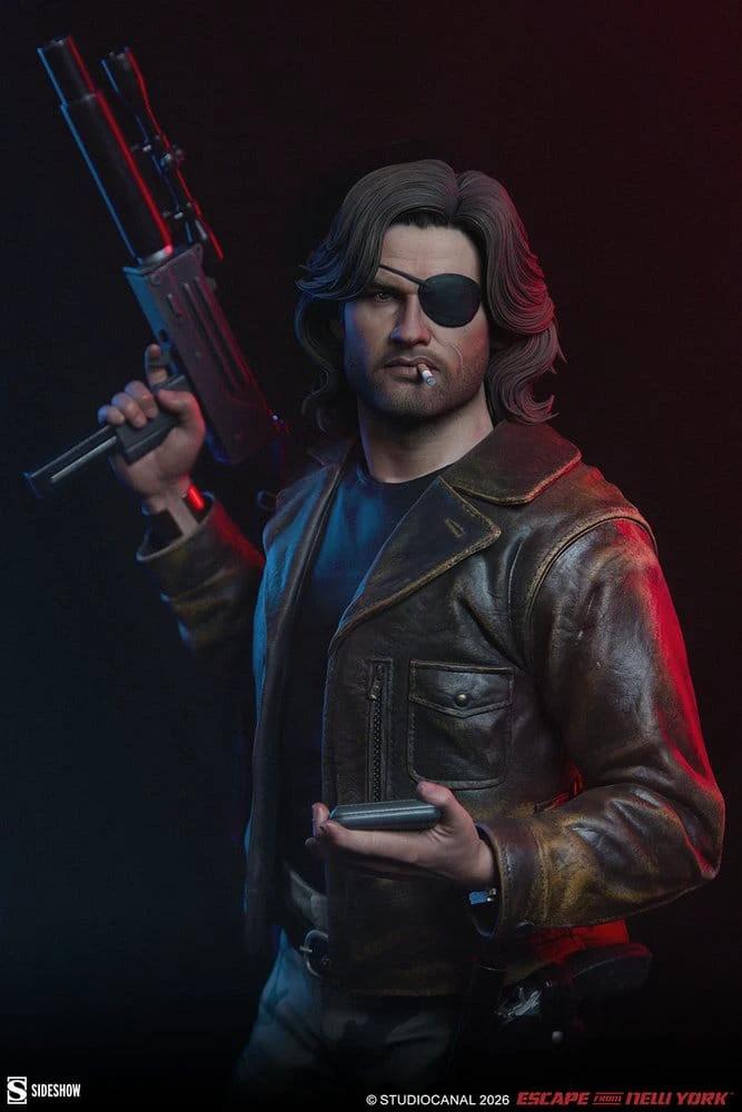 Figura premium Snake Plissken de Sideshow Collectibles, 57 cm, con chaqueta de cuero marrón, parche en ojo y cigarrillo.